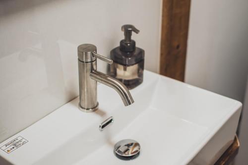 a bathroom sink with a faucet on a counter at サウナとアートの宿 瀬戸内一棟貸切 Sei-Jima Retreat in Sakaide