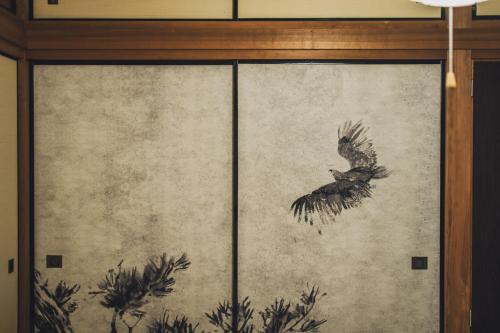 a painting of a bird on a wall at サウナとアートの宿 瀬戸内一棟貸切 Sei-Jima Retreat in Sakaide
