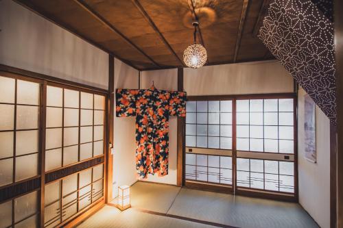 a room with windows and a cross on the wall at サウナとアートの宿 瀬戸内一棟貸切 Sei-Jima Retreat in Sakaide