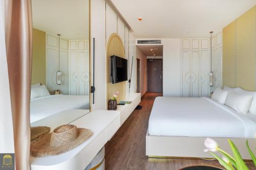 Postel nebo postele na pokoji v ubytování Apec Beach Mui Ne Resort