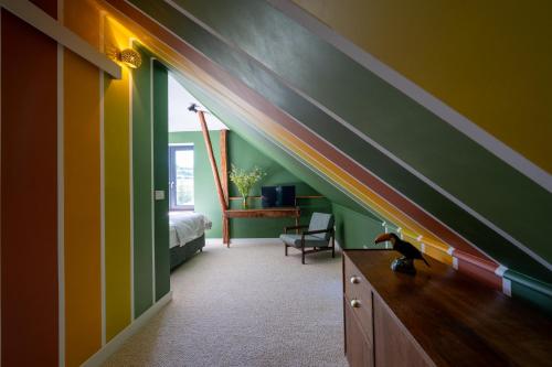 a room with a bed and a rainbow wall at Winnica Kosmos in Lubcza
