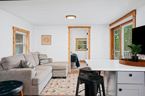 a living room with a couch and a table at Arbutus Lake-Pine Forest-Pontoon Rentals in Traverse City