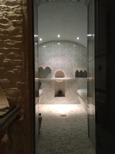 a bathroom with a glass door to a room with at LoveRoom Adults-Only in Maillezais