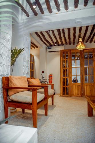 a living room with a couch and a table at Bellissimo Boutique Hotel in Zanzibar City