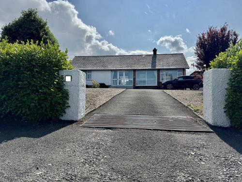 a house with a drain in the middle of a driveway at Forest Cottage in Newcastle