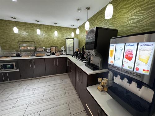 a kitchen with a counter with a tv and a counter at SureStay Plus by Best Western Alamogordo White Sands in Alamogordo