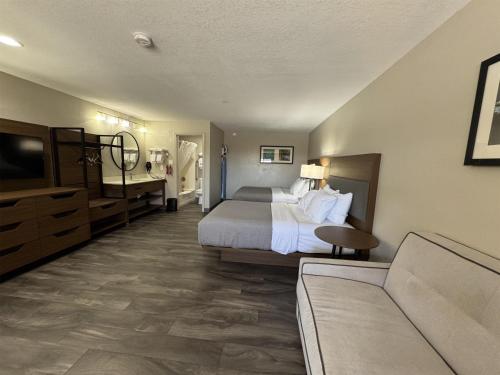 a hotel room with a bed and a couch at SureStay Plus by Best Western Alamogordo White Sands in Alamogordo