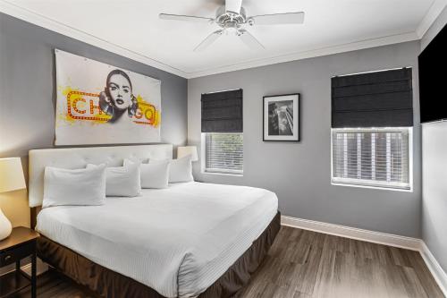 a bedroom with a large white bed with a ceiling fan at Hotel Chicago West Loop, SureStay Collection by Best Western in Chicago