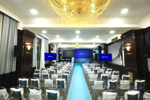 a banquet hall with chairs and a long table in a room at Radisson Blu GHR Rome in Rome