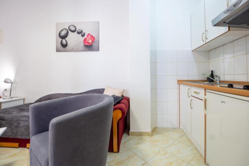 a kitchen with a couch and a table in a room at Villa Alesa Steva in Tučepi