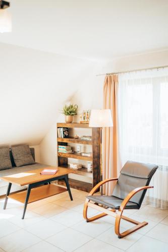 a living room with a chair and a coffee table at Rodzinny apartament FOLKER in Węgierska Górka