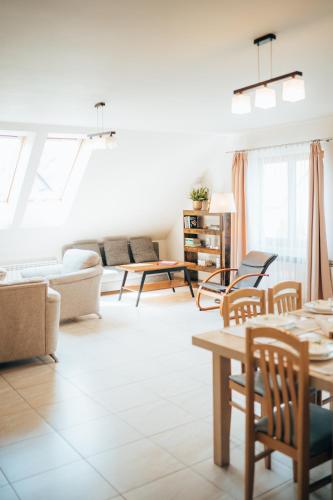 a living room with a couch and tables at Rodzinny apartament FOLKER in Węgierska Górka