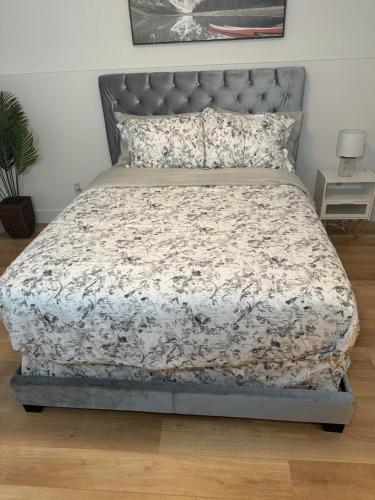 a bedroom with a bed with a gray headboard at One bedroom Apt in Riverview in Riverview