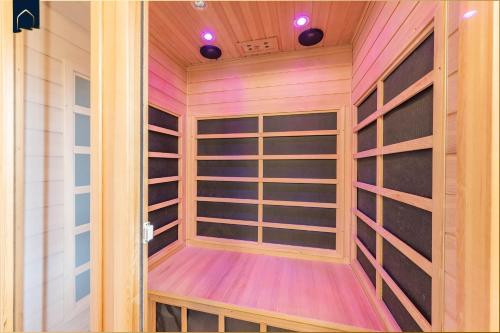 a sauna with wooden shelves and lights on the ceiling at Waldsiedlung DHH Waldhaus 5 in Korswandt