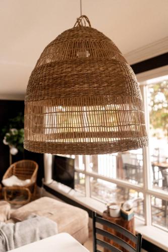 a large rattan light fixture in a living room at The Muskoka Nest in Windermere