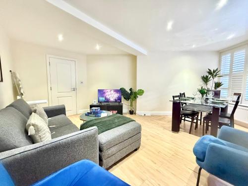 a living room with a couch and a table at 3-Bedroom Apartment with private Terrace in Pimlico, Westminster & Victoria by Staylio London in London