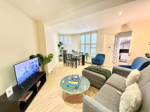 a living room with a couch and a tv at 3-Bedroom Apartment with private Terrace in Pimlico, Westminster & Victoria by Staylio London in London