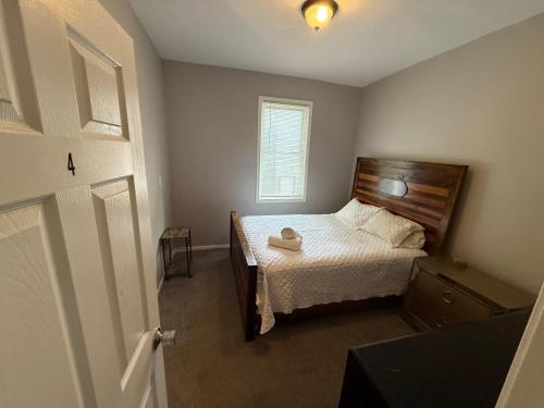 a small bedroom with a bed and a window at Wonderful Home Close to Downtown Chicago - Free Parking in Chicago