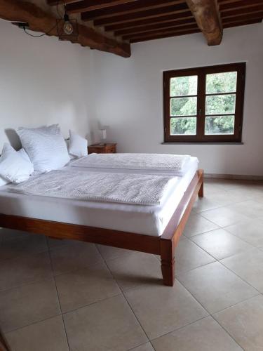 a bedroom with a large bed in a room at Tenuta Seripa in Sassetta