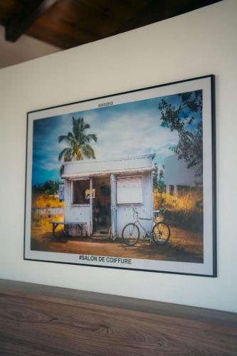 a picture of a bike in a frame on a wall at Les Ti Kaz d'Auguste in Les Avirons