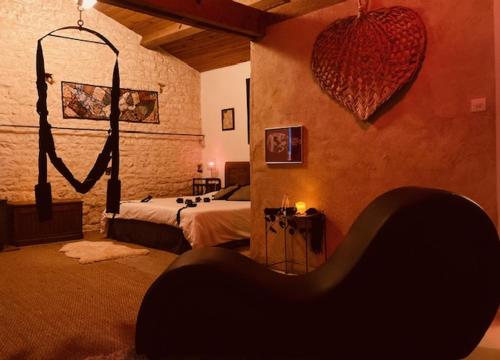 a bedroom with a bed and a mirror on the wall at LoveRoom Adults-Only in Maillezais