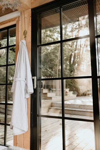 a white towel hanging on the door of a house at The Water’s Edge * * Unique Muskoka Treehouse * * in Windermere