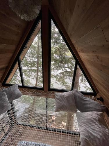 a room with a large window in a cabin at The Water’s Edge * * Unique Muskoka Treehouse * * in Windermere