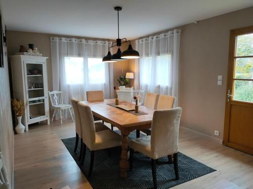 a dining room with a wooden table and chairs at House for 9 people in Saint-Clair-sur-lʼElle
