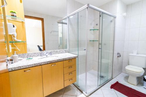 a bathroom with a shower and a sink and a toilet at Ozped Private Premier Flats in Brasília