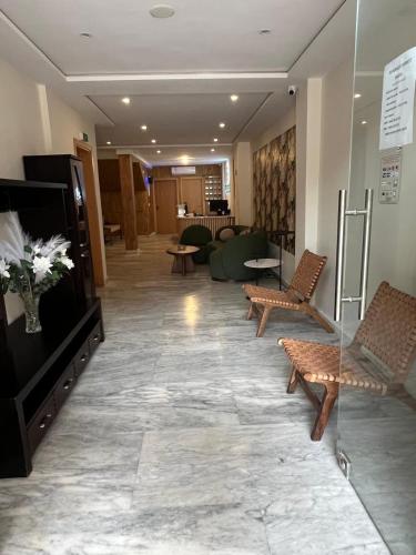 a lobby with chairs and a television in a building at Hôtel Everest, Séjour Balnéaire à Saïdia in Saidia 