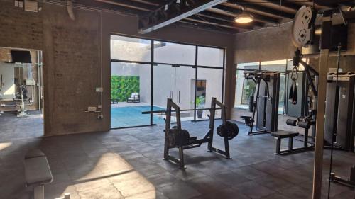 a gym with cardio equipment in a room with a large window at Gran Hotel Dakar in Mendoza