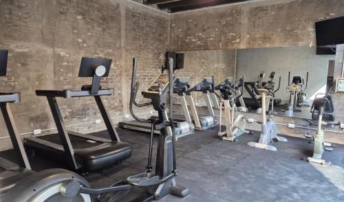 a gym with a bunch of treadms and cardio machines at Gran Hotel Dakar in Mendoza