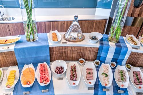a table with plates of food on it at City Lodge Hotel Waterfall City in Midrand