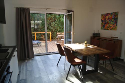 a kitchen with a table and chairs and a patio at Ferienhaus Lantana in Sankt Wendel