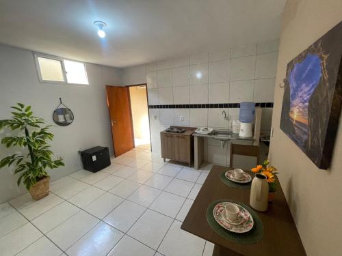 a kitchen with a table with plates on it at Apartamento completo e central! CASA DUNAS! in Fortaleza