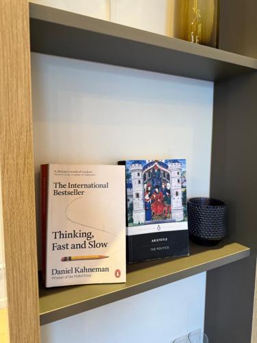 a book sitting on top of a shelf at Cozy Urban Apartment in Pristina