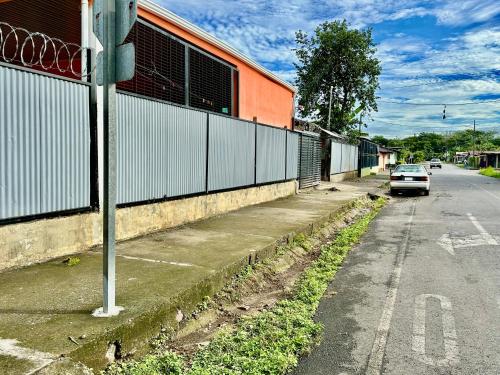 a white car parked on the side of a street at En-suite Paraiso #1 in Parrita