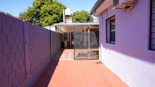 a fence in front of a house with a gate at The Posadas House in Posadas