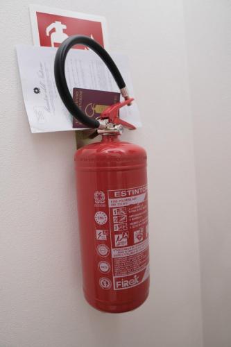 a fire hydrant with a hose attached to a wall at Casa Lumiere in Iglesias