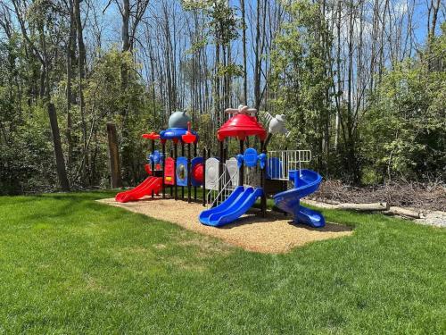 a park with a playground in the grass at Cozy 4-Bedroom Cottage #3 in Innisfil in Innisfil