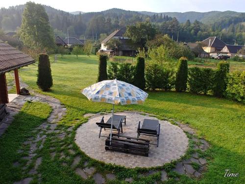 two chairs and an umbrella on a patio at Stavne 158 in Stavnoye