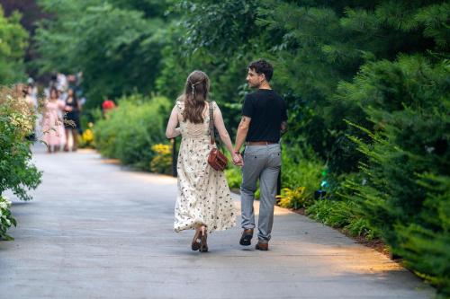 a man and a woman walking down a path at Staybridge Suites Hamilton - Downtown by IHG in Hamilton