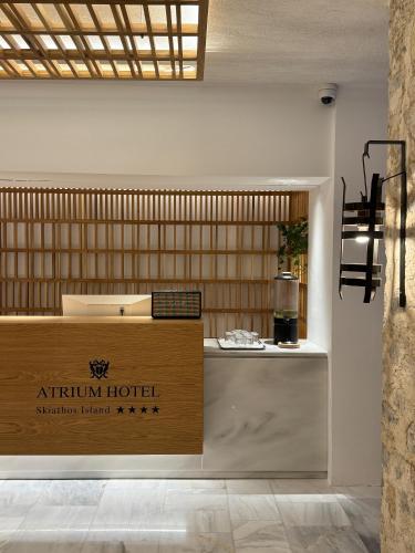 a sign for an atith hotel on a counter at Atrium Hotel in Agia Paraskevi