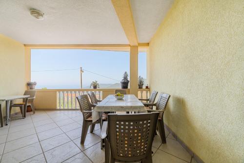 a dining room with a table and chairs on a balcony at Apartment Dragicevic 7 with Garage in Budva