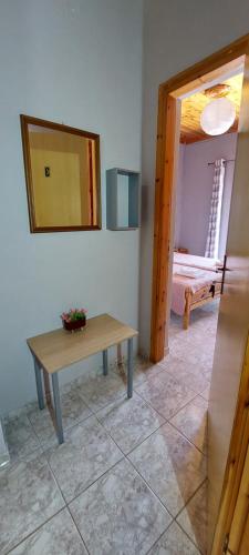 a room with a table and a mirror on the wall at Villa Nefeli in Loutsa