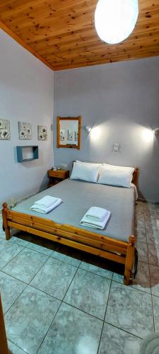 a bedroom with a large bed in a room at Villa Nefeli in Loutsa