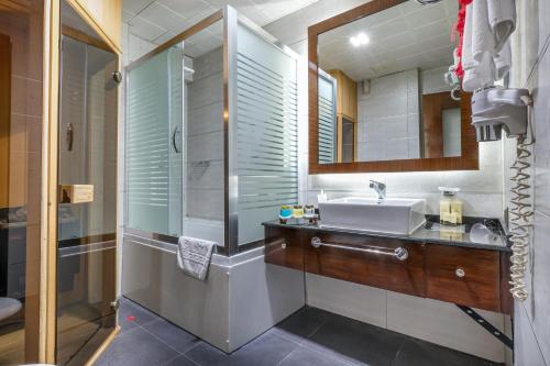 a bathroom with a sink and a shower at Marlight Boutique Hotel in Izmir