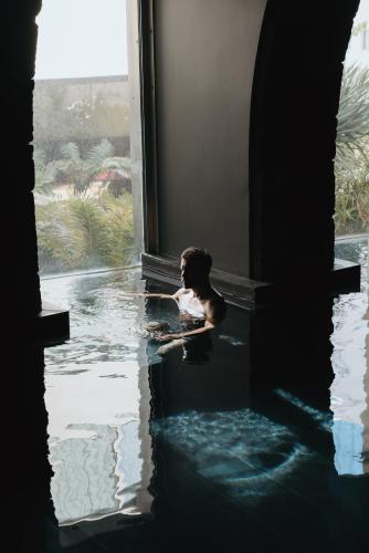 a boy in a pool of water in a building at NINE DOTS Azorean Art Boutique Hotel in Ponta Delgada