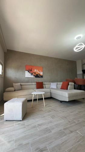 a living room with two couches and a table at Lotus Apartments in Vlorë