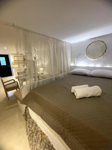 a bedroom with a large bed with a mirror at Anetta's House in Agia Marina